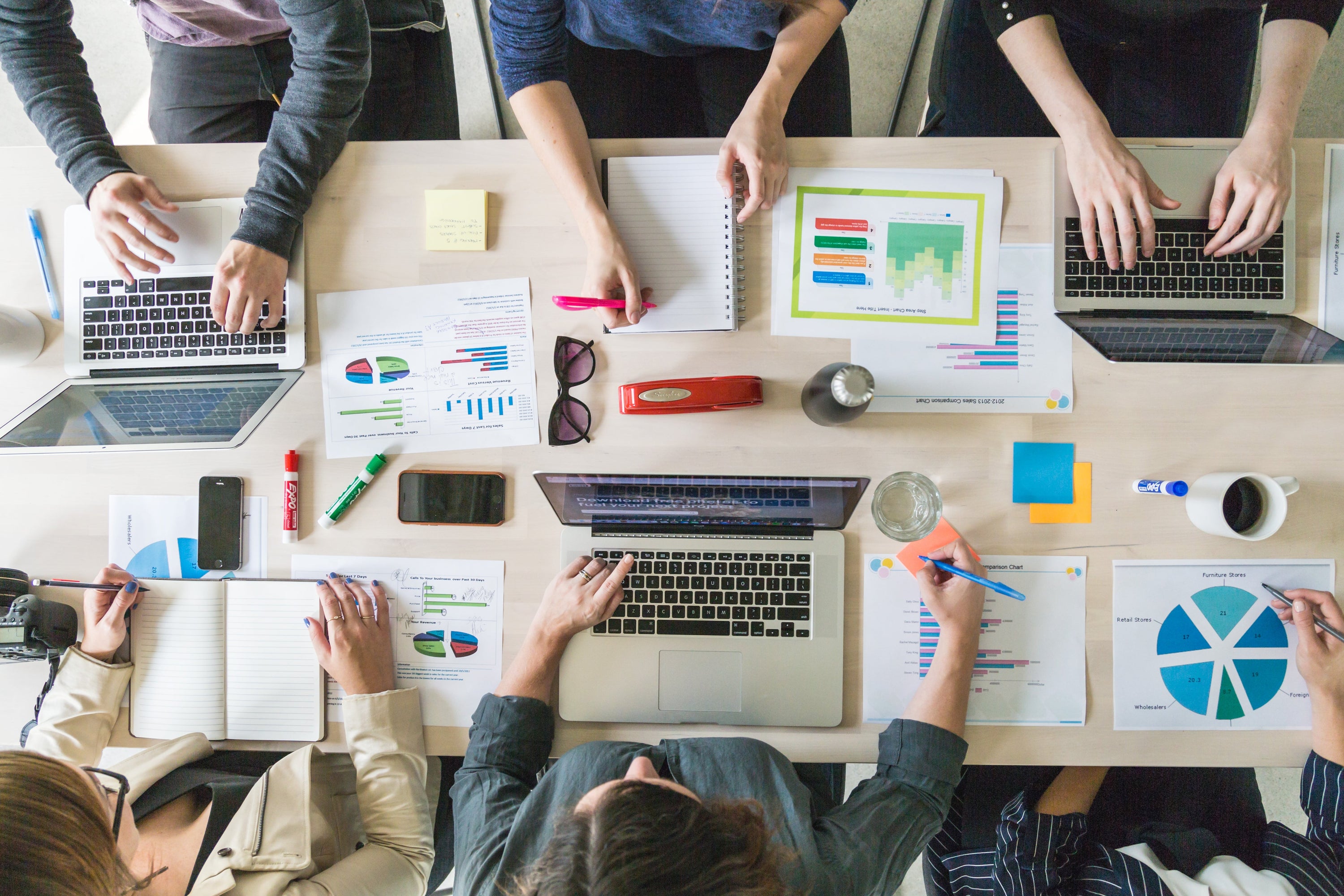 This team is ready to brainstorm, tackle sales or come up with new business ideas as they gather around the boardroom table. With this many pie charts and graphs at hand, a group like this can only succeed