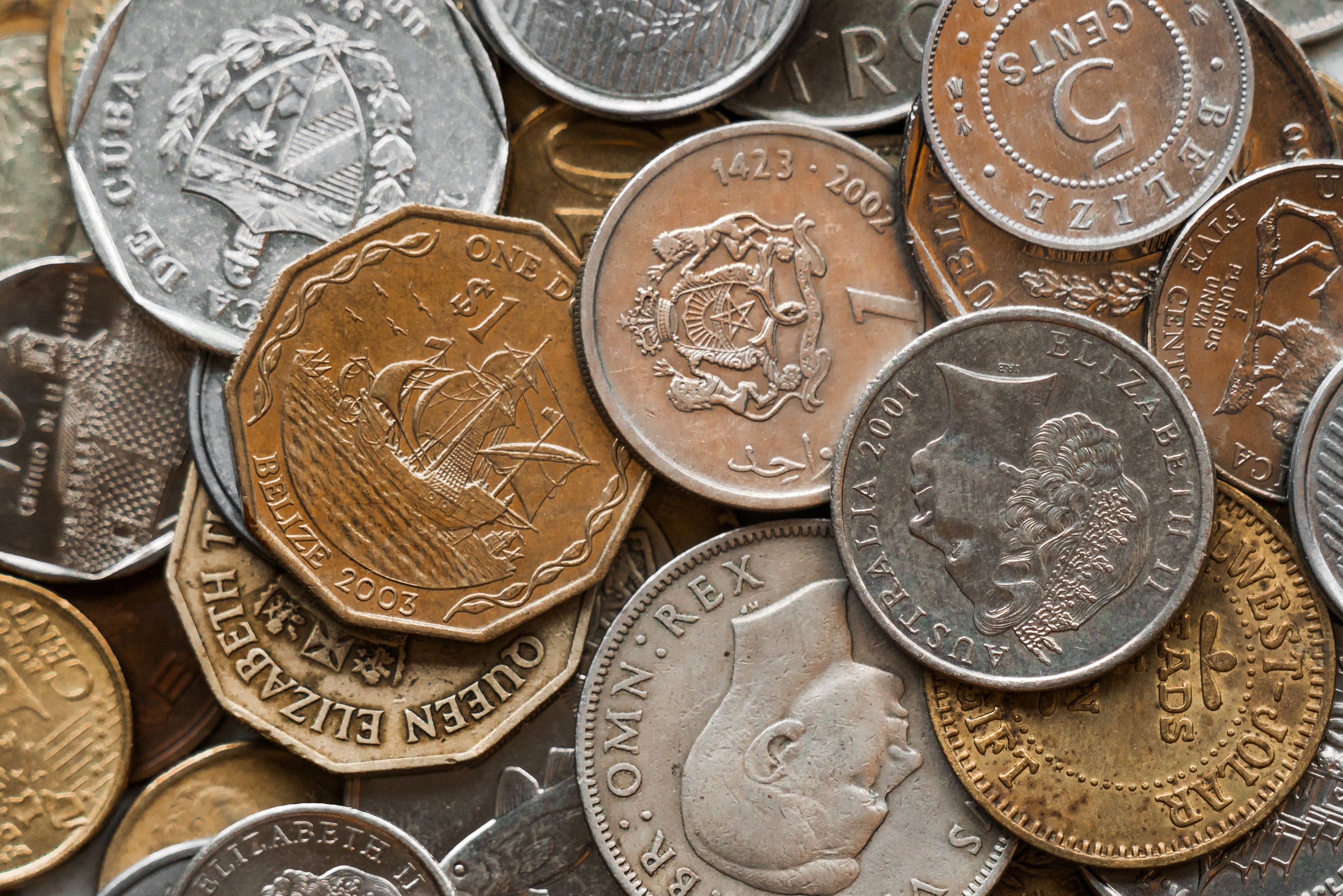 Coins from around the world in a pile.