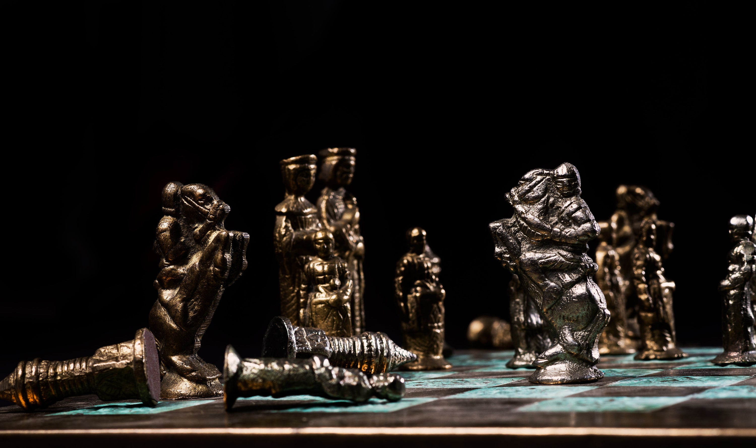 The rearing horses of two battling knights on a chess-board as the King and Queen look on. This game takes a great deal of intelligence and strategy.