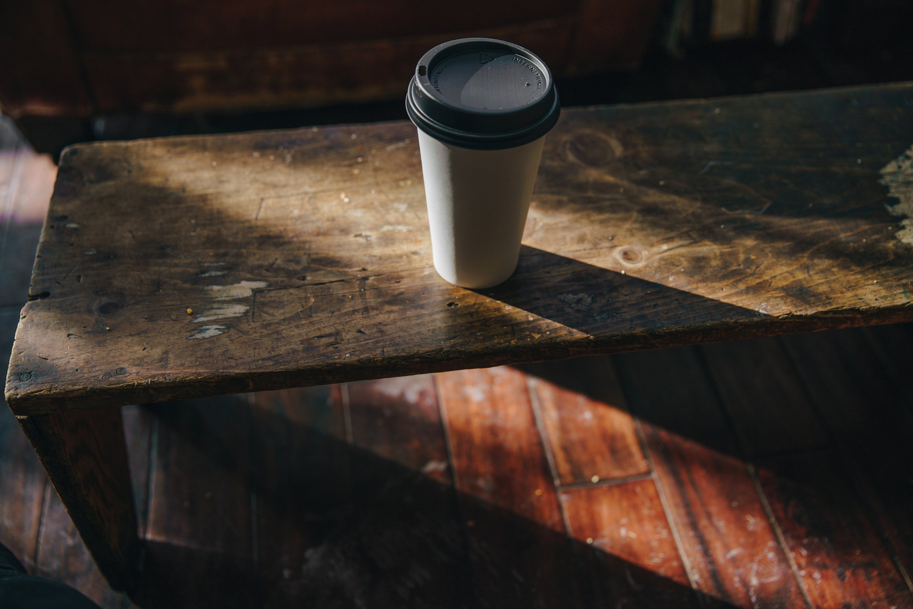 White Coffee Takeaway Cup on a Wooden Bench