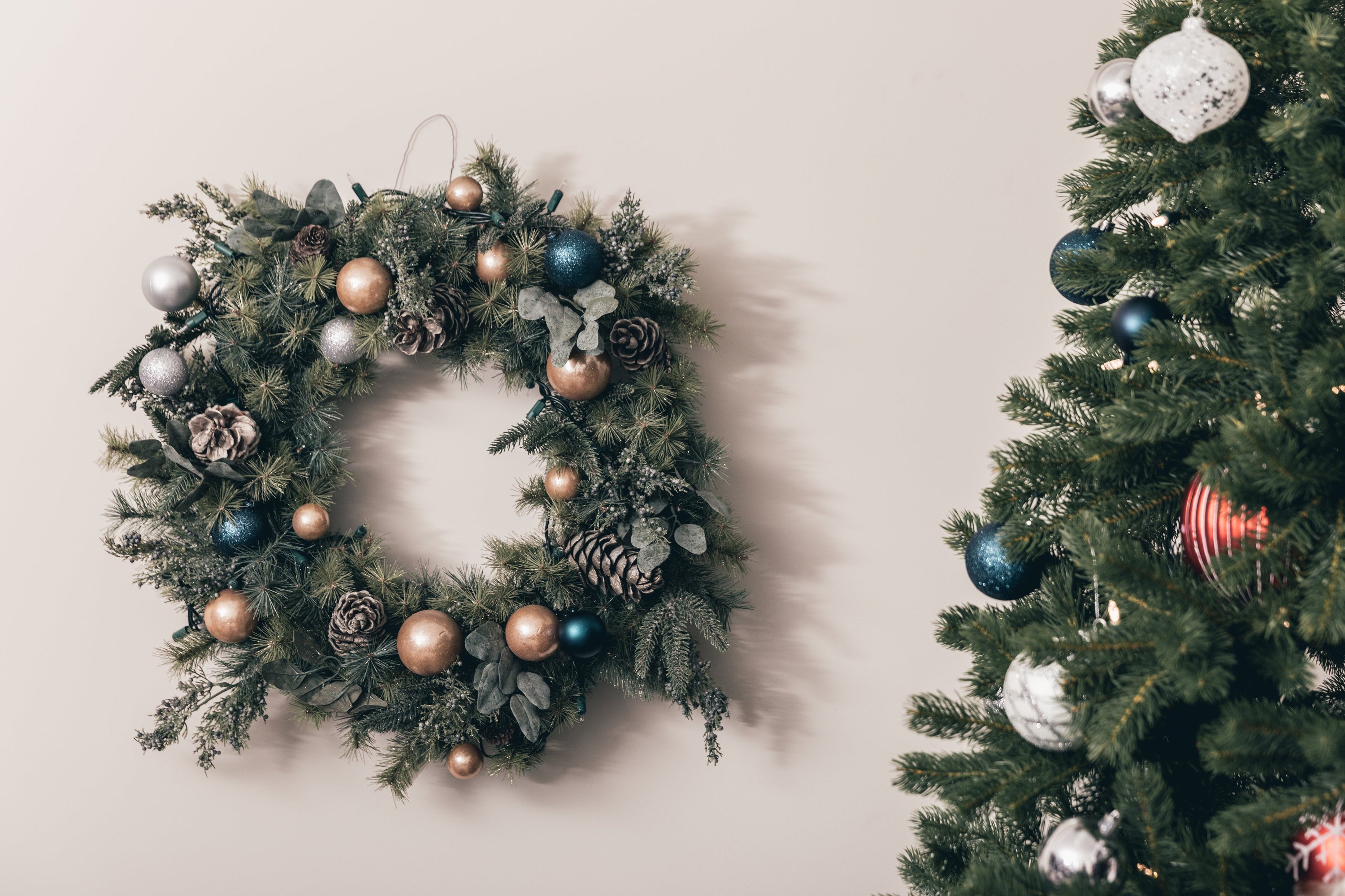 No Christmas is complete without a wreath. Hung beside a Christmas tree, the two Christmas staples feature matching ornaments in blue, gold and silver