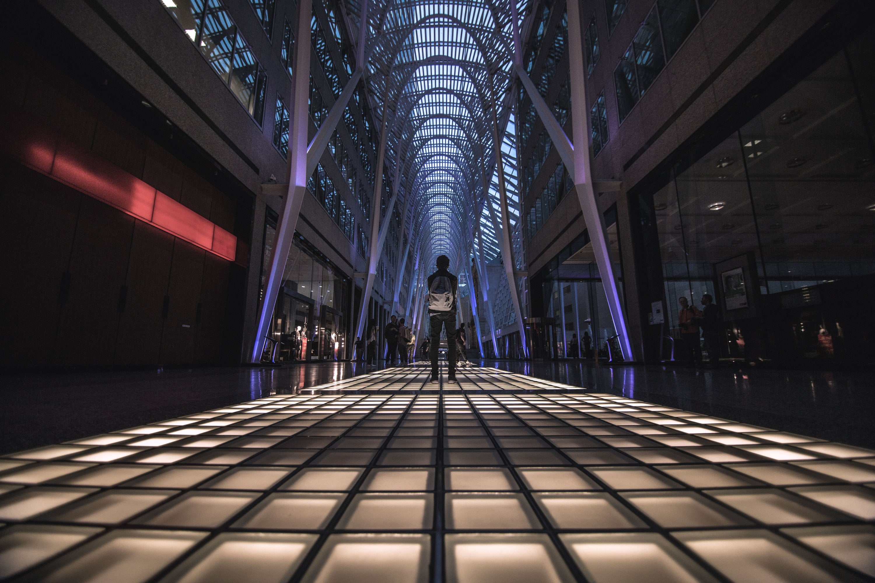 A man standing in the middle of a lit floor