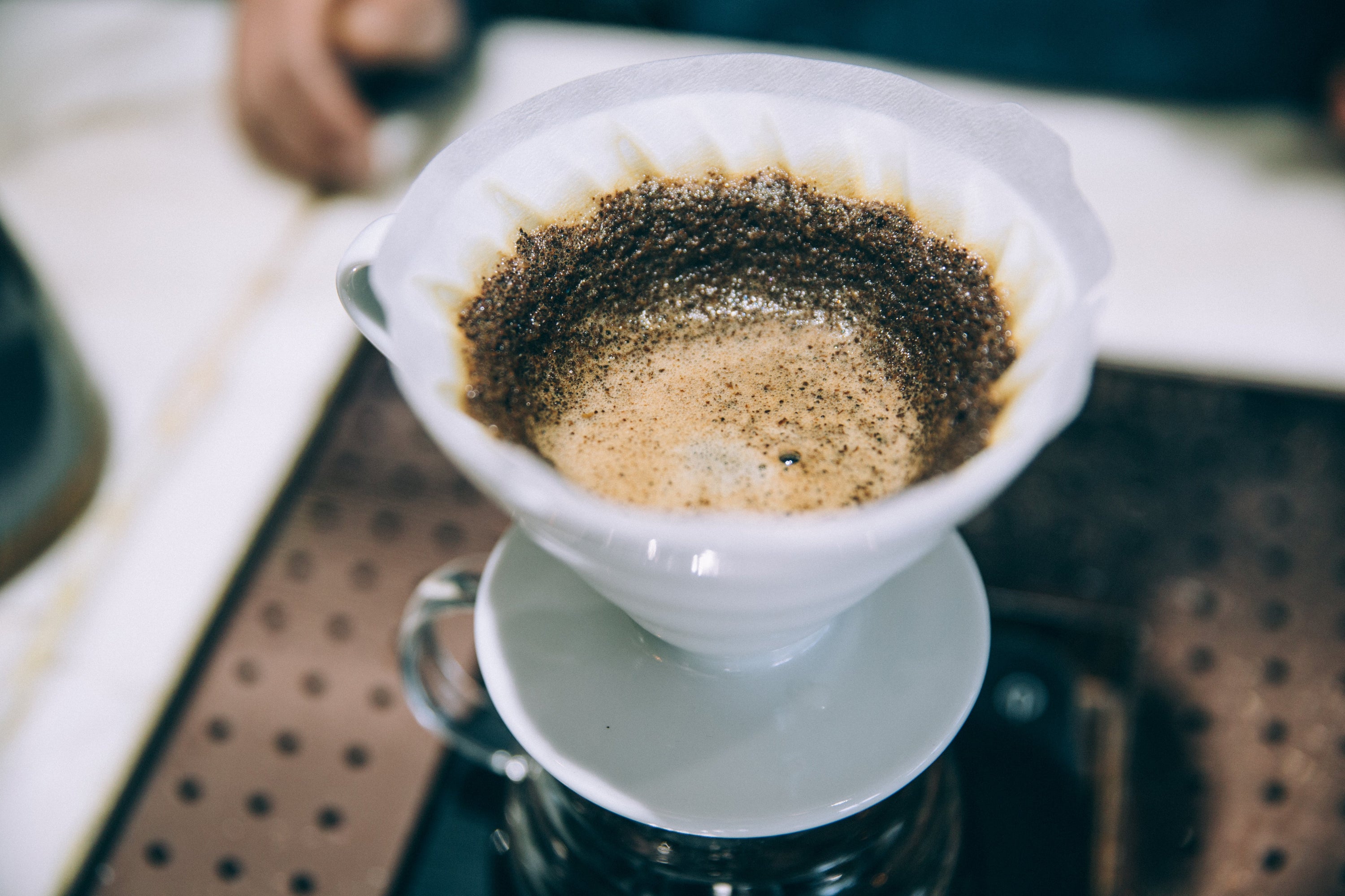 The careful process of pour over coffee being brewed